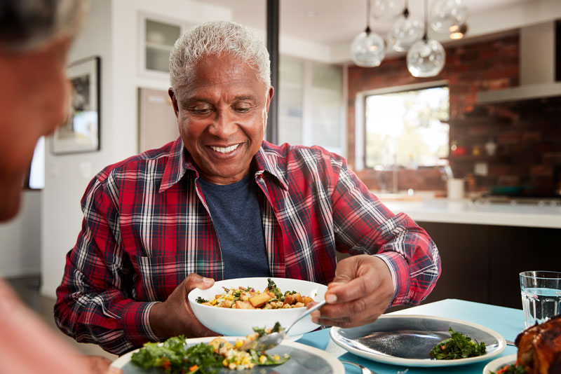 Dental Implant Patient Eating While Smiling